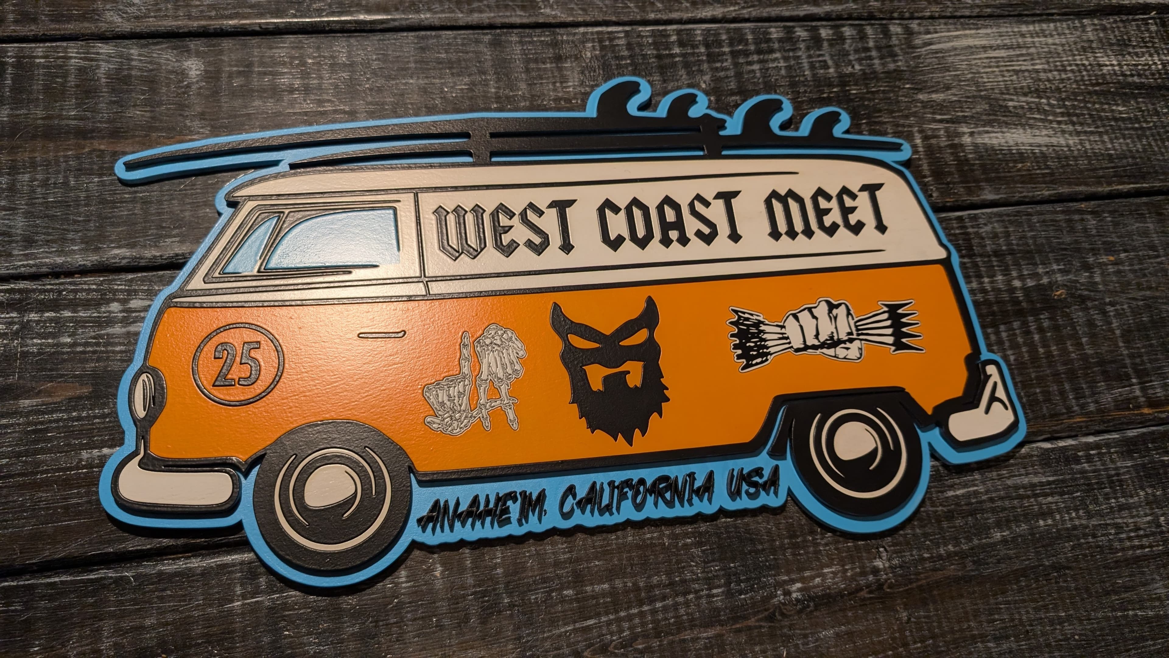Custom van-shaped event sign with bright orange and blue details