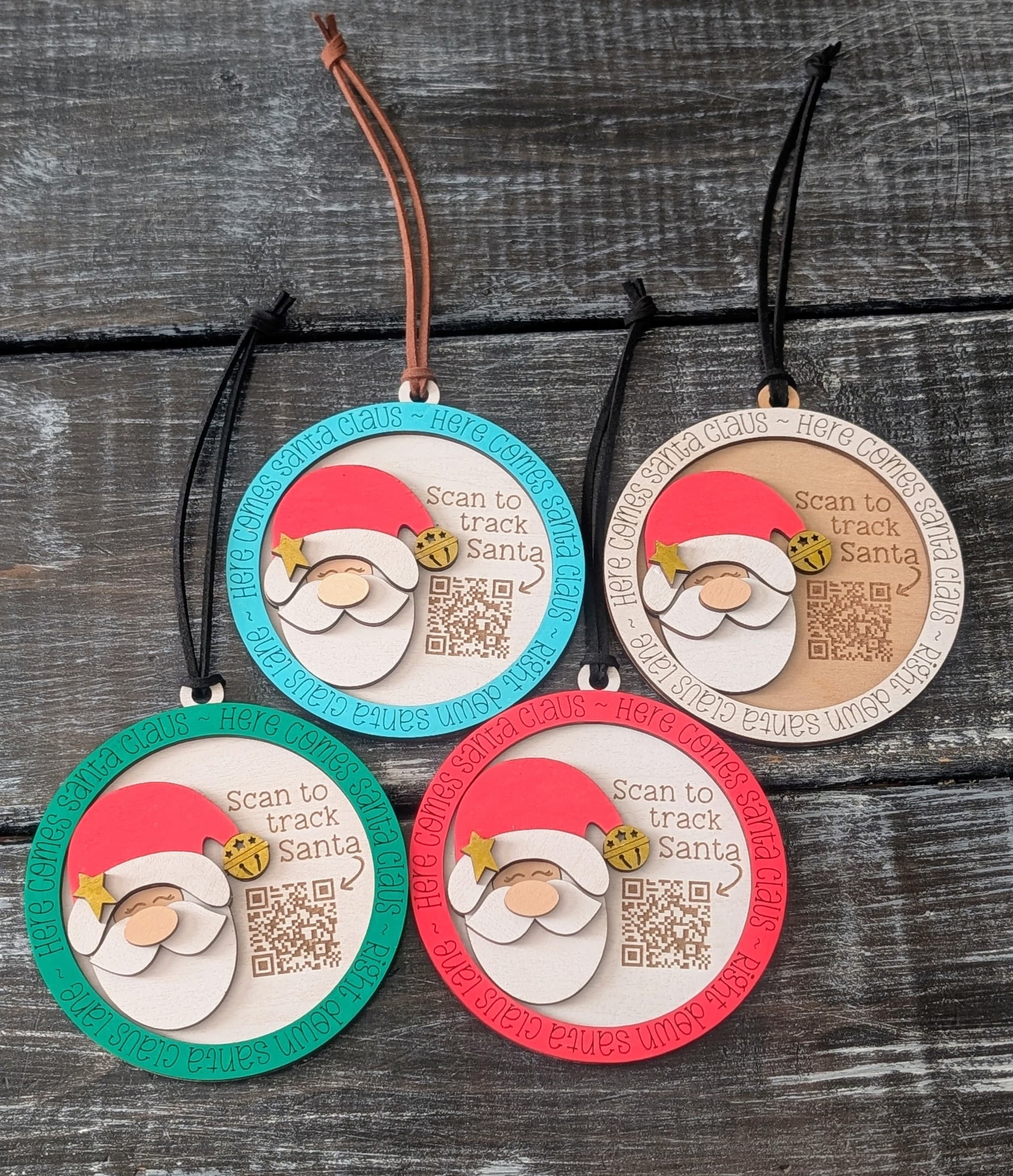 Colorful Santa tracker ornaments arranged on a dark tabletop