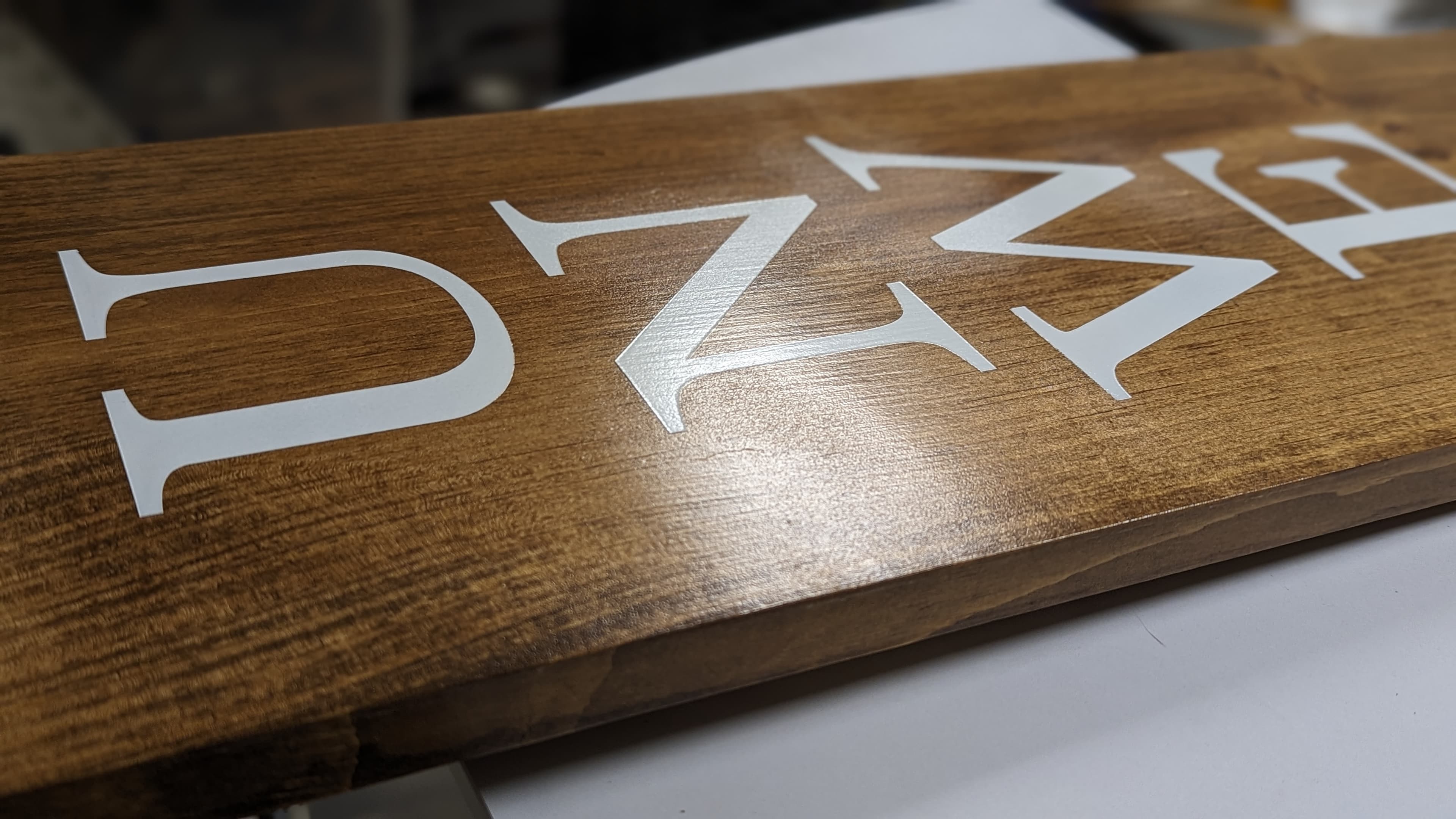 Close detail of painted raised lettering during fabrication
